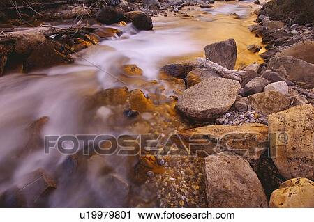 Stock Image - A close-up (closeup close up) of a rushing stream. Fotosearch