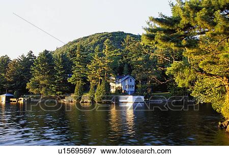 Stock Photo - A cottage on a lake. Fotosearch