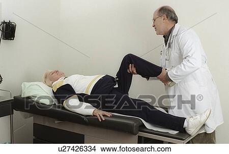 Picture - A doctor carrying out an examination. Fotosearch