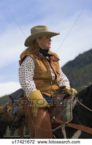 Stock Image - A portrait of a woman on horseback. Fotosearch