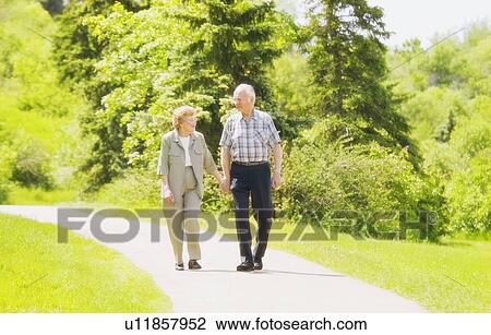 A senior couple taking a stroll View Large Photo Image Stock Image - A senior couple taking a stroll. Fotosearch