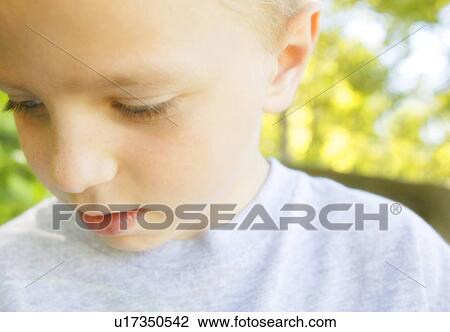 A young boy looking down View Large Photo Image Stock Image - A young boy looking down. Fotosearch