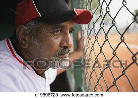 Baseball player in dugout View Large Photo Image Stock Photo - Baseball player in dugout. Fotosearch