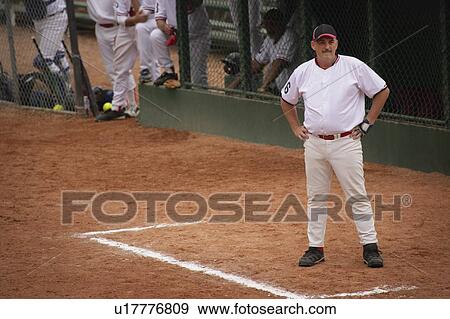 Stock Photo - Baseball player waiting for turn. Fotosearch