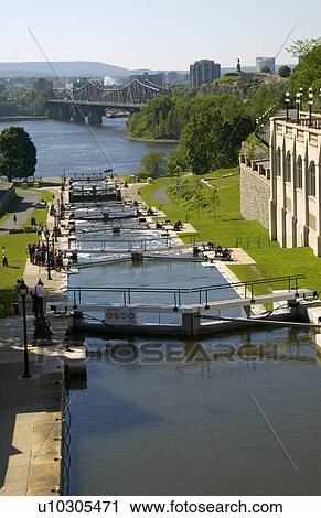 Stock Image - Canal, locks and distant skyline. Fotosearch