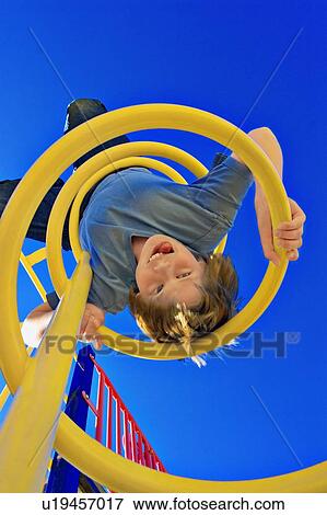 Child hangs on upside down View Large Photo Image Stock Photo - Child hangs on upside down. Fotosearch