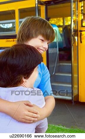Stock Photograph - Child hugs mother good-bye. Fotosearch