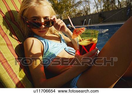 Child relaxes beside pool View Large Photo Image Picture - Child relaxes beside pool. Fotosearch