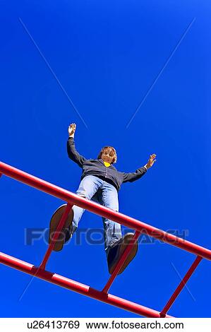 Child stands tall at playground View Large Photo Image Stock Photo - Child stands tall at playground. Fotosearch