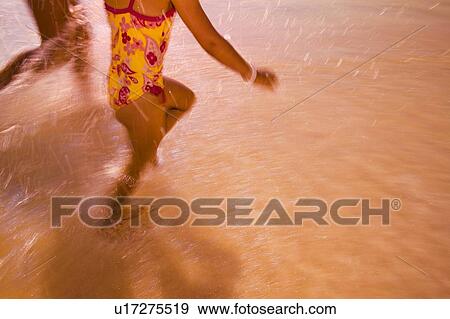 Children run through the water View Large Photo Image Stock Photo - Children run through the water. Fotosearch