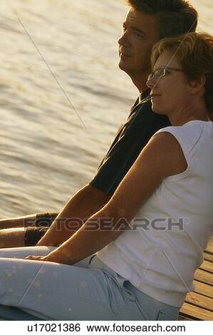 Stock Photograph - Couple looking out over water. Fotosearch