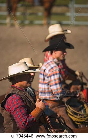Stock Photograph - Cowboys look on. Fotosearch