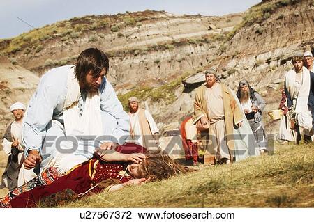 Crowd watches as Jesus helps person lying on ground View Large Photo Image Stock Image - Crowd watches as Jesus helps person lying on ground. Fotosearch