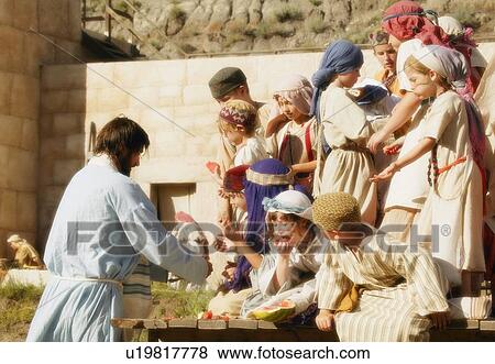 Stock Photo - Jesus feeding children. Fotosearch