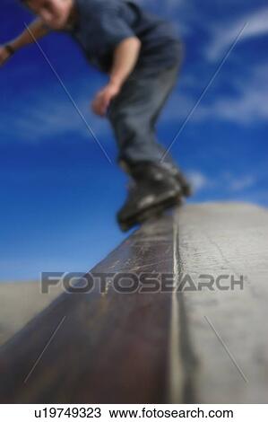 Stock Image - Skating down a ramp. Fotosearch