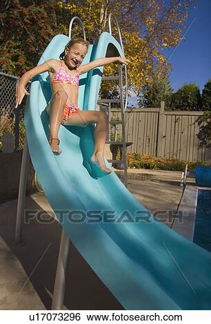 Stock Photograph - Sliding down a slide. Fotosearch