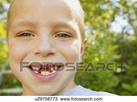 Stock Image - Smiling boy missing teeth. Fotosearch