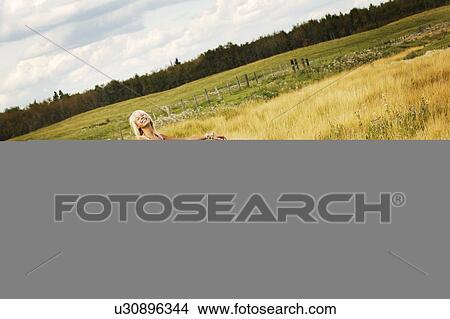 Picture - Teen girl walking through field. Fotosearch