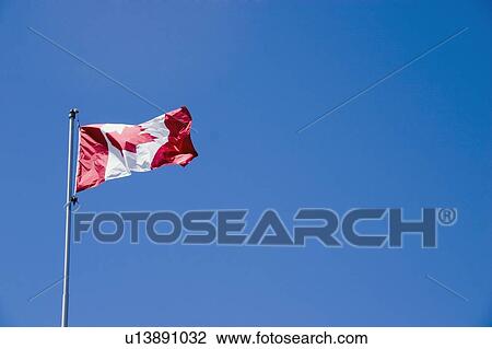 Stock Image - The Canadian flag in the wind. Fotosearch