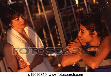 Two women chatting in the guy View Large Photo Image Stock Image - Two women chatting in the guy. Fotosearch