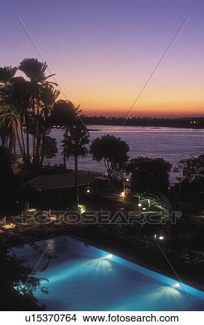 View over swimming pool, hotel, Nile River, Luxor, Egypt View Large Photo Image Picture - View over swimming pool, hotel, Nile River, Luxor, Egypt. Fotosearch