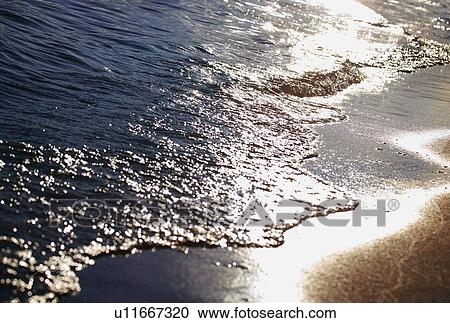 Stock Image - Water Coming up on Beach. Fotosearch