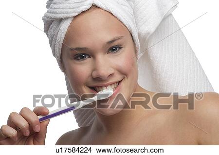 Woman brushing teeth View Large Photo Image Picture - Woman brushing teeth. Fotosearch