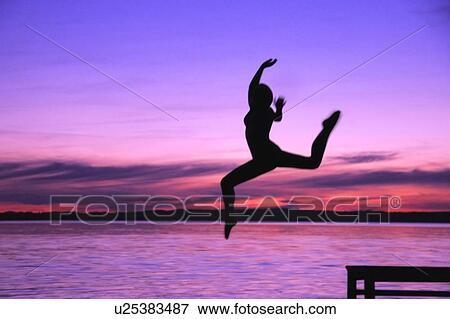 Woman leaps into the water View Large Photo Image Stock Photo - Woman leaps into the water. Fotosearch