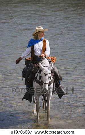 Woman riding horse View Large Photo Image Stock Photo - Woman riding horse. Fotosearch