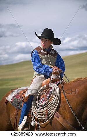 Young Cowboy on horse View Large Photo Image Stock Photo - Young Cowboy on horse. Fotosearch
