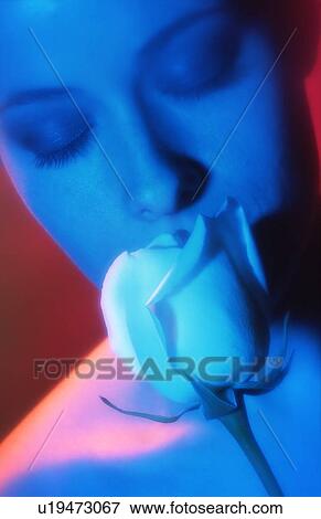 Young woman Smelling a Rose View Large Photo Image Stock Photo - Young woman Smelling a Rose. Fotosearch