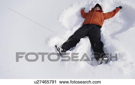 Boy making snow angel View Large Photo Image Stock Image - Boy making snow angel. Fotosearch