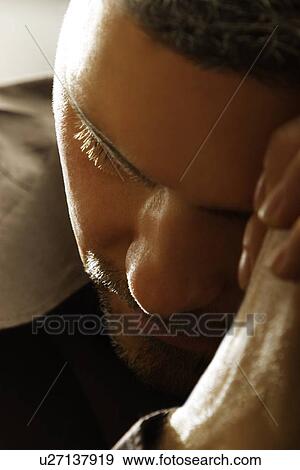 Stock Photo - Close up of a man praying. Fotosearch