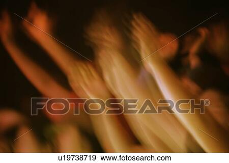Stock Photo - Hands raised at a concert. Fotosearch