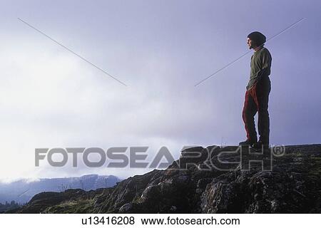 Hiker looking out at the horizon View Large Photo Image Stock Photo - Hiker looking out at the horizon. Fotosearch