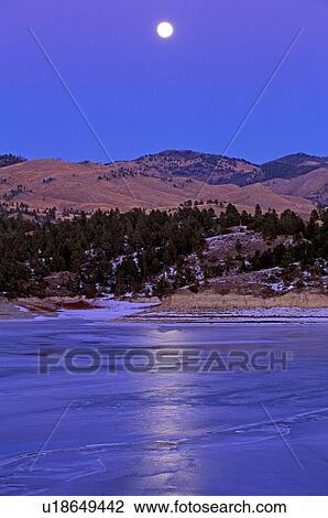 Stock Image - Moonrise, Canyon Ferry Lake, winter. Fotosearch