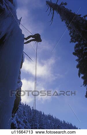 Person scaling frozen waterfall View Large Photo Image Stock Image - Person scaling frozen waterfall. Fotosearch