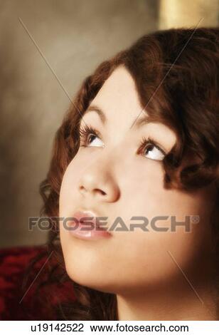 Stock Image - Portrait of a woman looking up. Fotosearch