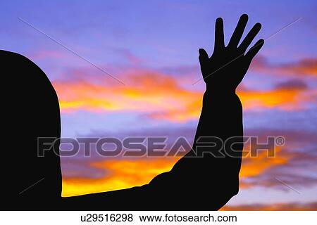 Stock Photo - Silhouette of raised hand. Fotosearch
