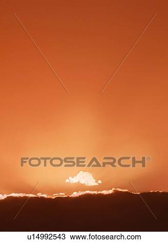 Sun setting behind clouds View Large Photo Image Stock Image - Sun setting behind clouds. Fotosearch