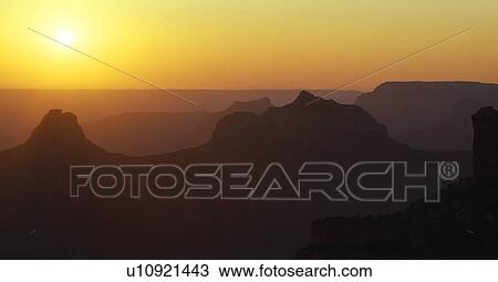 Stock Image - Sun setting over Grand Canyon buttes, Grand Canyon National Park. Fotosearch
