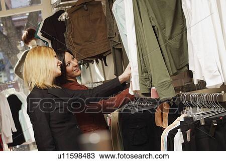 Stock Image - Two young adults shopping. Fotosearch