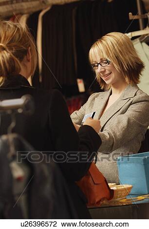 Stock Image - Woman buying clothes. Fotosearch
