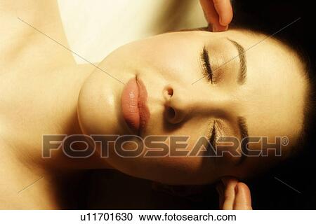 Stock Image - Woman having face massaged. Fotosearch