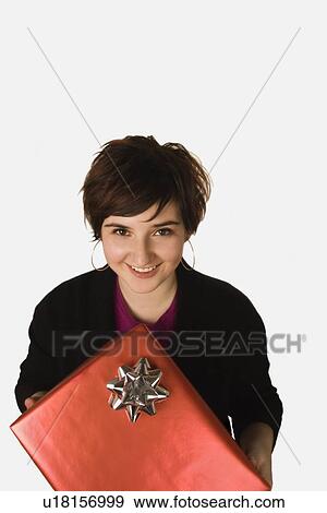 Woman holding present View Large Photo Image Stock Photo - Woman holding present. Fotosearch