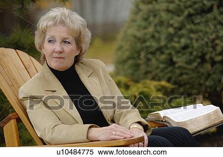 Woman looking off during devotions View Large Photo Image Stock Photography - Woman looking off during devotions. Fotosearch