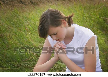 A teenager prays View Large Photo Image Stock Photo - A teenager prays. Fotosearch
