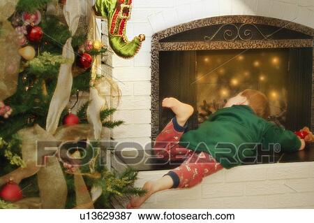 Stock Photo - Child checks for Santa. Fotosearch