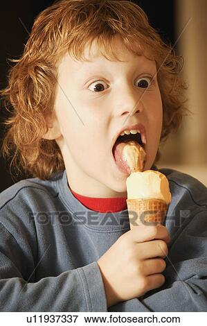 Child eats ice cream View Large Photo Image Stock Photo - Child eats ice cream. Fotosearch