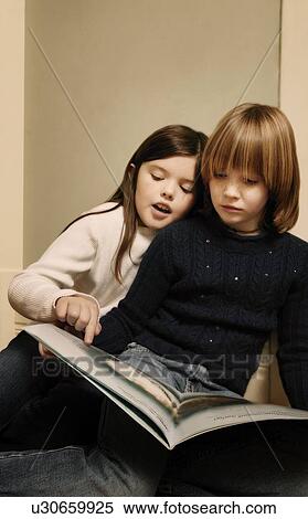 Children looking at story book View Large Photo Image Stock Photography - Children looking at story book. Fotosearch